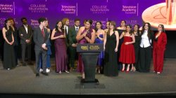Dani Mazariegos, a senior majoring in Journalism and Digital Media, stands on stage accepting the Seymour Bricker Humanitarian Award on behalf of the Arizona Stories team at the 44th College Television Awards in Los Angeles. She is surrounded by 13 fellow student journalists, all dressed in formal evening attire, celebrating their win.